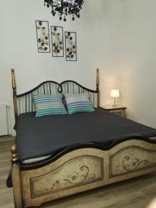 a bedroom with a large wooden bed with two pillows at Stay In Tmisoara in Timişoara