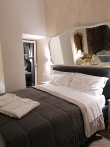 a bedroom with a large bed with a large mirror at Real Giardinetto a Toledo in Naples