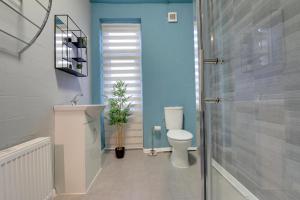 a bathroom with a toilet and a sink and a shower at Stylish base on Abbeydale Road in Sheffield