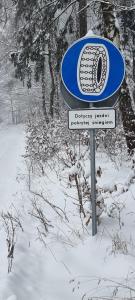 a blue and white sign in the snow at Level780 in Koszarawa
