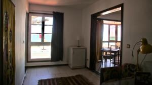 a living room with a door open to a patio at La Maison Jaune Dakhla Maison d'hôtes in Dakhla