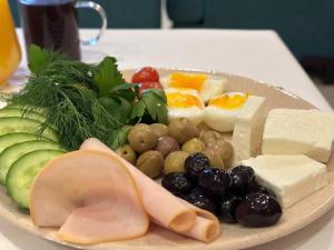 a plate of different types of food on a table at Deer Hostel & Hotel in Antalya