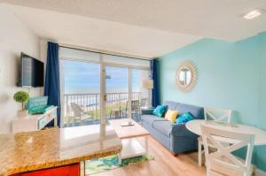 a living room with a couch and a table at Sea Watch Resort in Myrtle Beach