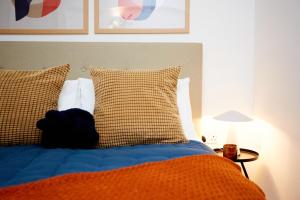 a bed with a teddy bear sitting on top of it at Luxury new built split-level flat with rooftop gardens access in Manchester