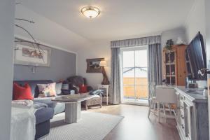 a living room with a couch and a table at Haus Victoria in Sankt Gilgen