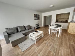 a living room with a couch and a table at tirou 5 centre - gare - aéroport in Charleroi
