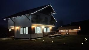 a house lit up at night with lights on it at Casa EVA in Panaci