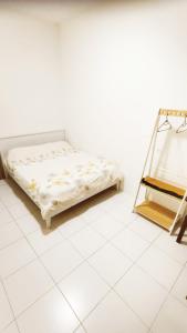 a bed sitting on a tiled floor in a room at The Quintet Condominium 3-1 in Tanah Rata