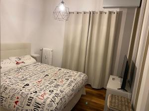 a bedroom with a bed and a tv and curtains at Nice104 in Turin