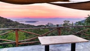 a bench sitting on top of a mountain with a sunset at La Casetta nel Bosco in Ischia