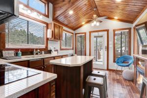 a kitchen with wooden ceilings and a ceiling fan at The Casitas at Las Tortugas - La Hacienda in Driftwood +19 photos