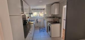 a kitchen with a white refrigerator and a dishwasher at PLAYA RINCON De LA VICTORIA in Rincón de la Victoria