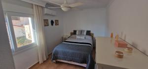 a bedroom with a bed and a ceiling fan at PLAYA RINCON De LA VICTORIA in Rincón de la Victoria