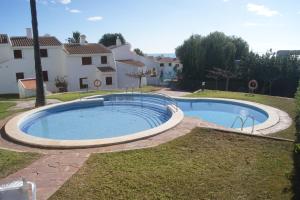 a large swimming pool in a yard with a house at Las Haciendas Marineu in Alcossebre