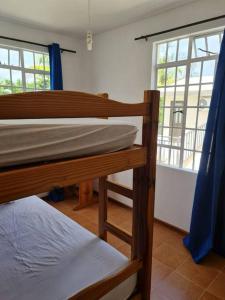 a bedroom with two bunk beds and a window at Vacation Beach House South of Mauritius - Riambel in Riambel