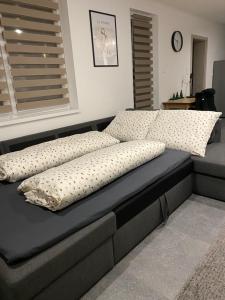 a bed with pillows on it in a bedroom at TWIN HOUSE in Gyál