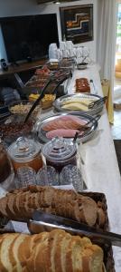 a buffet of food on a table with bread at Vanta Hotel in Limenas