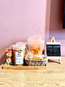 a basket of food and a sign on a table at Apartment in Ladang Tok Pelam in Kuala Terengganu