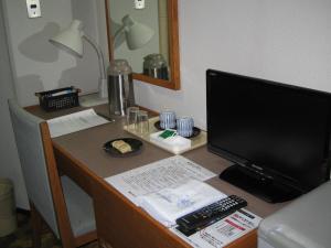 a desk with a laptop and a monitor at Takimoto Inn in Noboribetsu