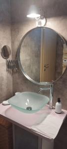 a bathroom sink with a large mirror above it at Apollo Romantic Sea View Villa in Kiveri