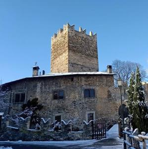 an old stone building with a tower on top of it at B&B La Tour de Villa in Aosta
