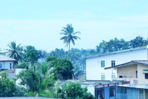 a view of a city with palm trees and buildings at YOUTHENI VILLA in Weligama