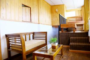 a living room with a couch and a table and stairs at YOUTHENI VILLA in Weligama