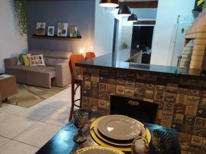 a living room with a table with plates on it at Apartamento Por do Sol - Cobertura in São Roque