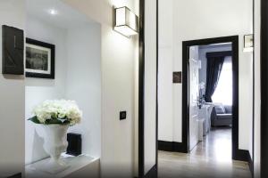 a room with a white wall and a mirror at Residenza Scipioni Luxury B&B in Rome