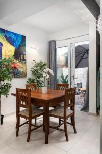 a dining room with a wooden table and chairs at 1 Bedroom Apartment with cosy Backyard close to Valletta in Il-Furjana