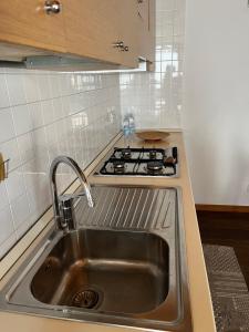 a kitchen with a sink and a stove at Al Piccolo Clarin in Mestre