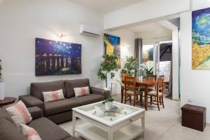 a living room with a couch and a table at 1 Bedroom Apartment with cosy Backyard close to Valletta in Il-Furjana