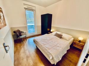 a bedroom with a large bed and a window at Les terrasses in Saint Malo
