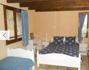 a bedroom with a bed and a window at Ferme La Siberie in Entrevaux