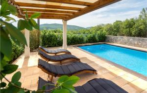 a patio with chairs and a swimming pool at Gorgeous Home In Trilj With House A Mountain View in Trilj