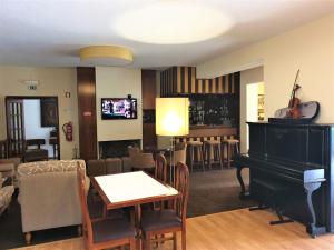 a living room with a piano and a bar at Hotel Verde Pinho Bed&Breakfast in São Pedro de Moel