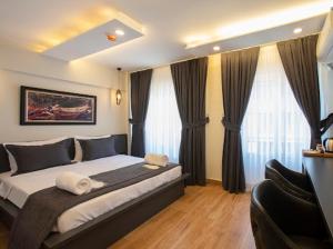 a bedroom with a large bed with curtains at Kanarya Suite in Istanbul