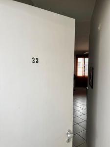 a hallway with a door with the number on it at Nosso apê no Guarujá - Unidade Aquário in Guarujá