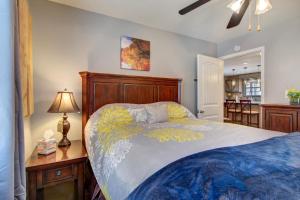 a bedroom with a bed and a table with a lamp at Rio House Retreat in Tazewell