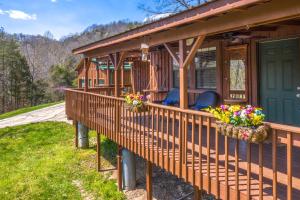 a porch of a house with flowers on it at Rio House Retreat in Tazewell