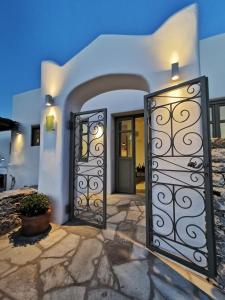 a white house with a pair of doors at Vorina Ktismata in Amorgos