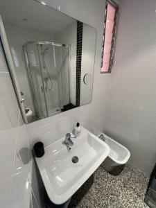 a white bathroom with a sink and a toilet at Acacias IV 15A in Benidorm