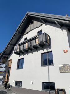 a white building with a balcony on it at Hiša Pod gorami II****-house with wellness in Kranjska Gora