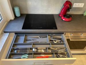 a drawer in a kitchen with utensils in it at Duinenblik 5 in Nieuwpoort