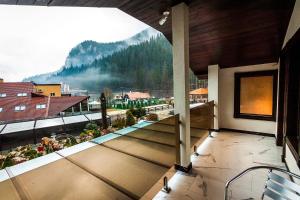 a balcony with a view of a mountain at Hotel Lacu Rosu in Lacu Rosu