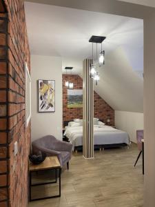 a bedroom with two beds and a brick wall at Dwór Bysina in Myślenice