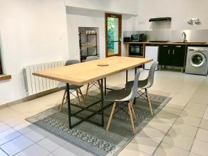 a kitchen with a wooden table and two chairs at Le Moulin in Mesland