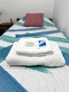una pila de toallas sentadas encima de una cama en Depto pleno centro de Salta ! hasta 5 personas en Salta