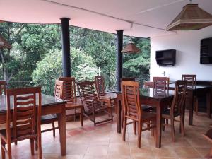 a dining room with wooden tables and chairs at New Kandy Residence in Kandy