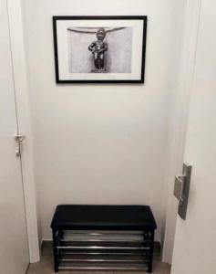 a black stool in a room with a picture on the wall at BRUSSELS EXPO APARTMENT in Brussels